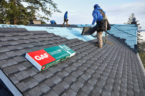 Roofers reroofing wearing fall restrant.Quality Materials: The Backbone of a Long-Lasting Roof